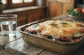 Best traditional Italian eggplant gratin recipe layered with fresh tomato sauce, sliced eggs and melted bubbling parmesan cheese crust.